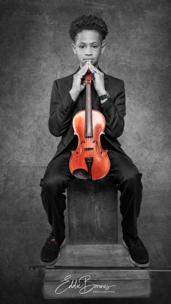 A young boy with his Violin in the Luxury Photography Studio