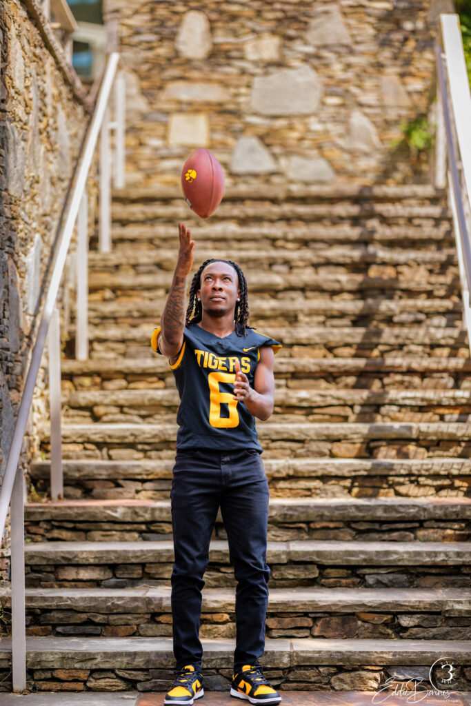 Young man throwing a football downtown Greenville SC