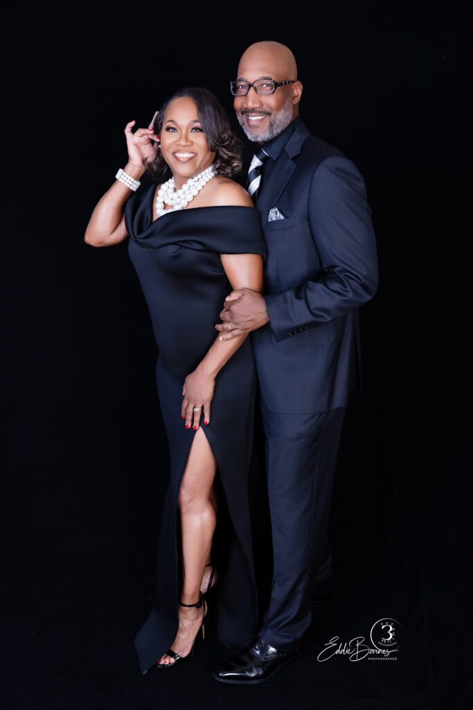 Elegant anniversary couple standing together in Greenville SC studio portrait.